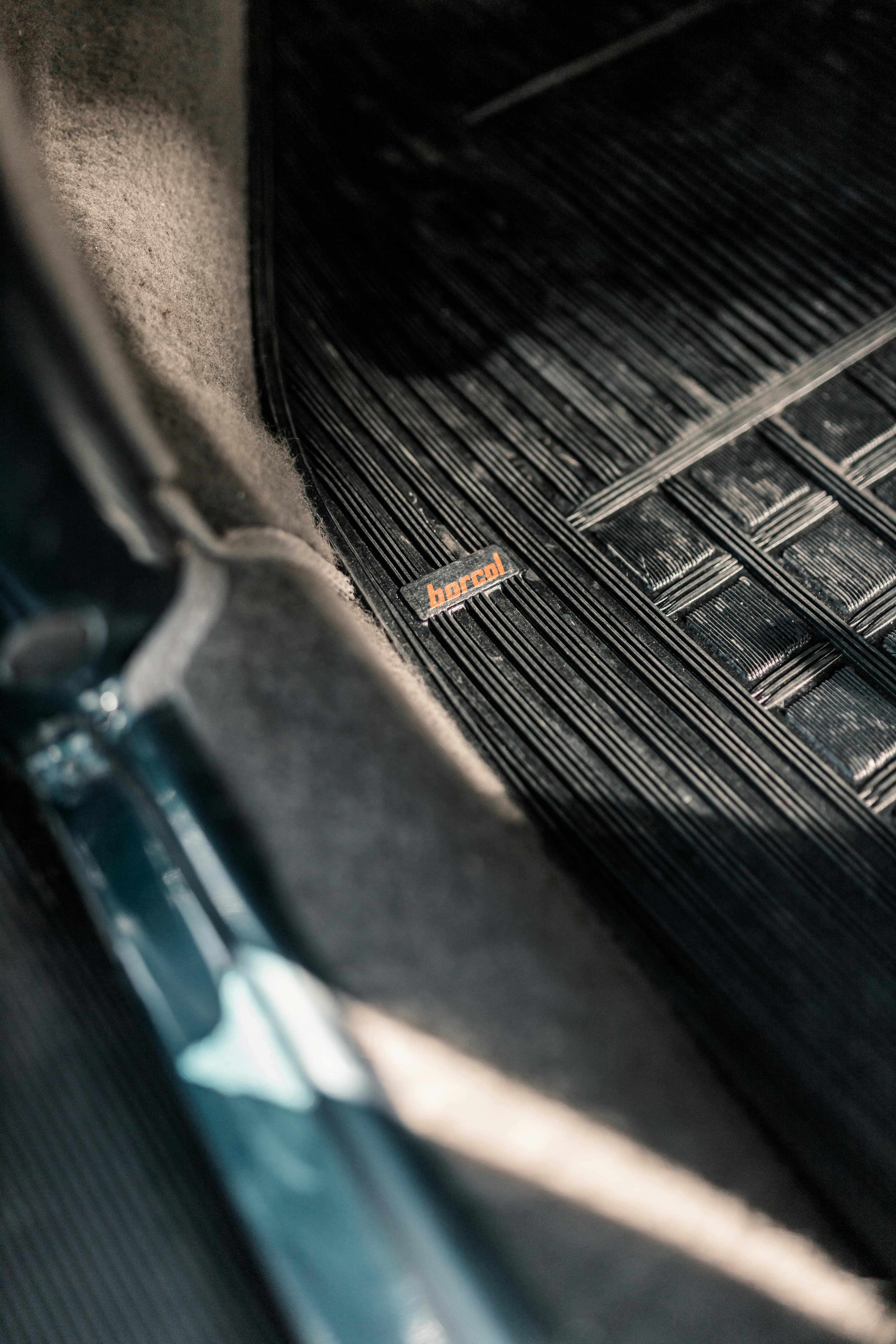 Custom-fit weather floor mats laid in a vehicle interior.